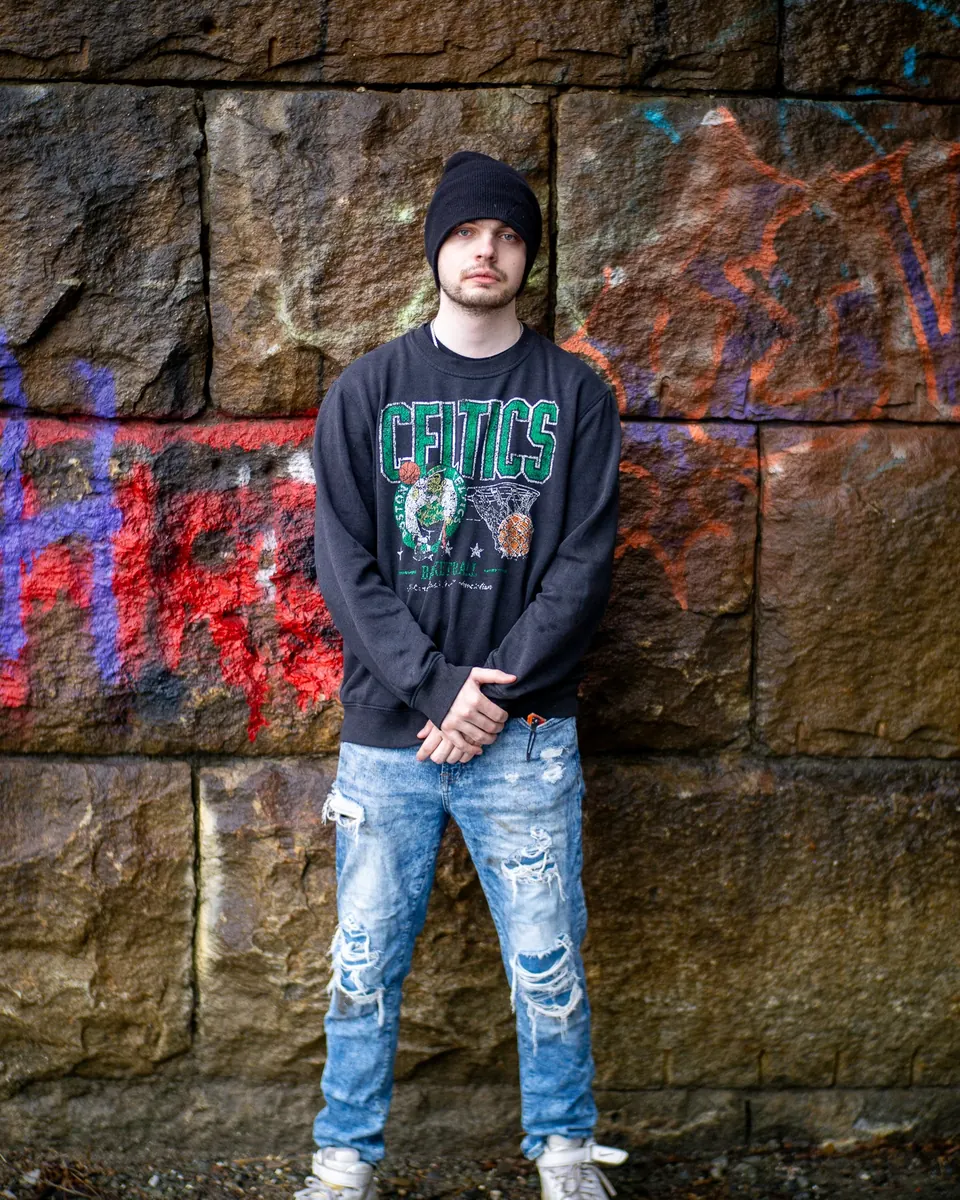 Portrait against a graffiti-covered stone wall
