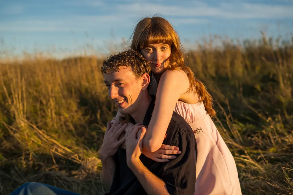 Couple hugging in tall golden grass